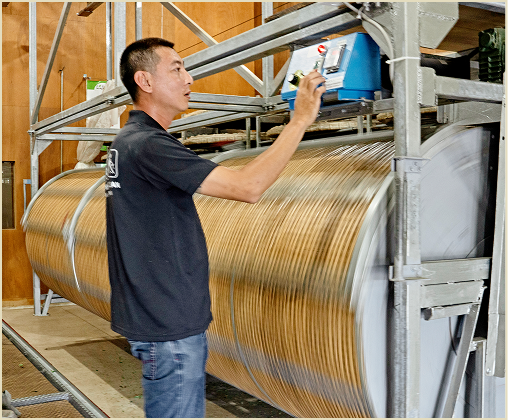 A man setting up the waving machine.
