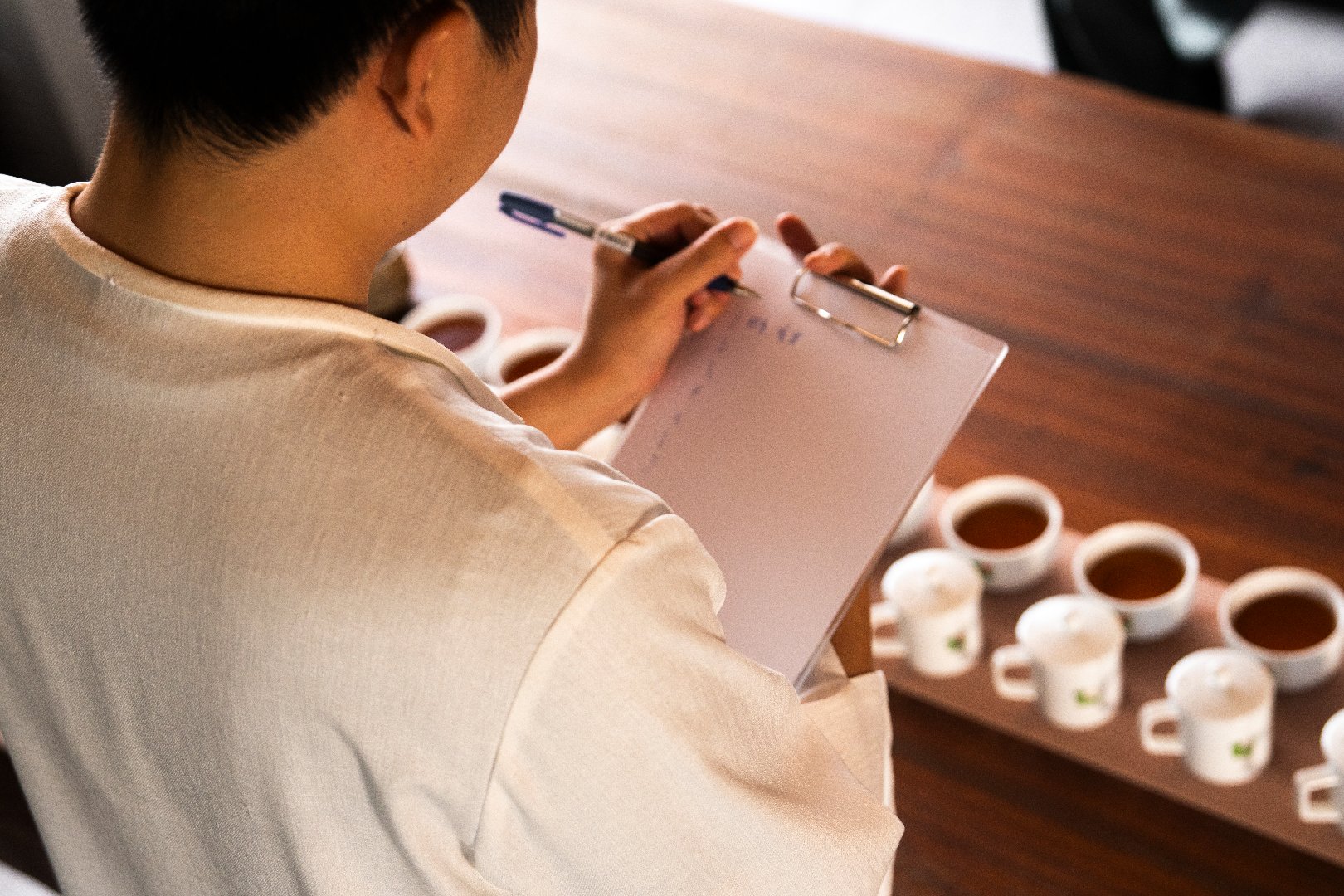 A man recording the tasting results.