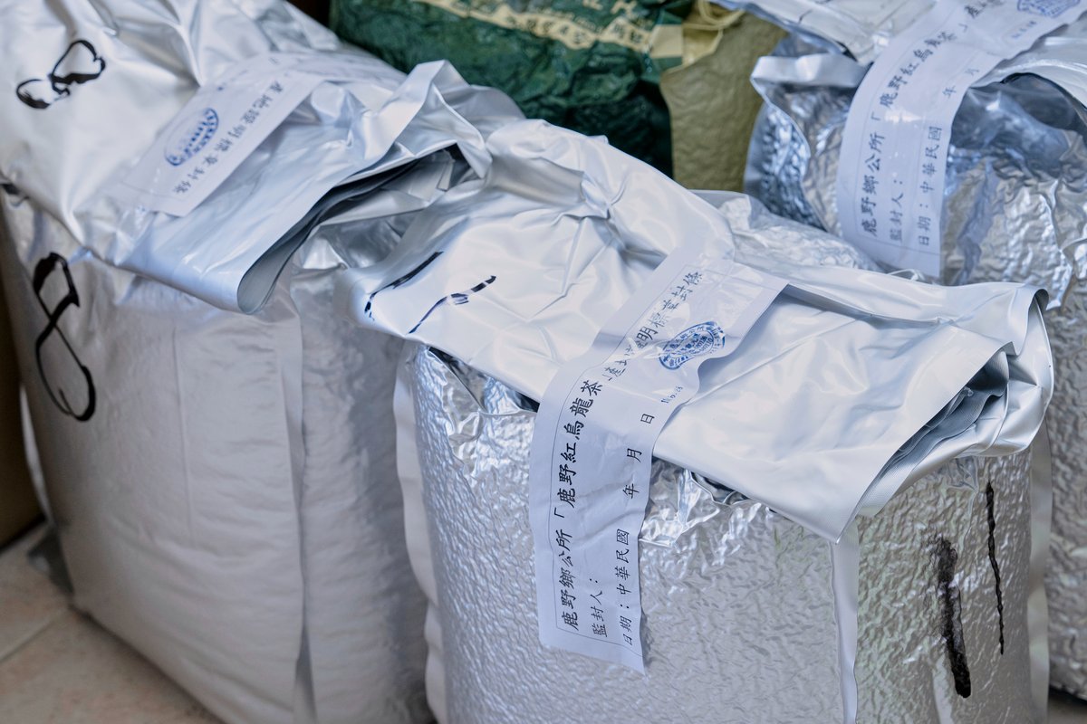 Bags of sealed raw leaves waiting to be inspected.