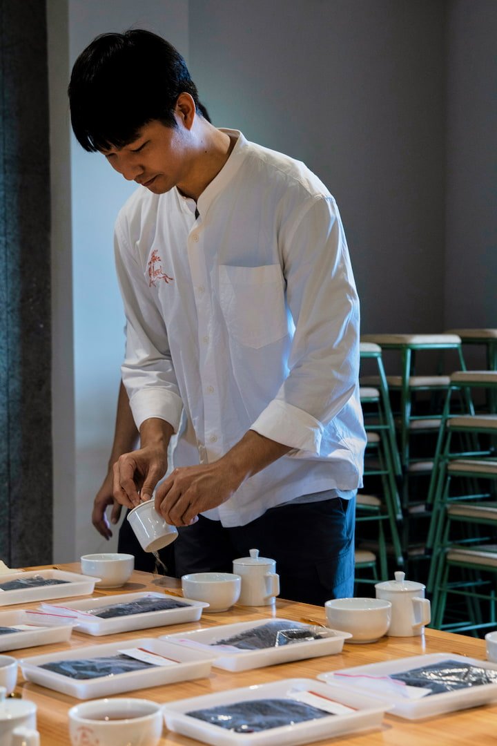 An intern in the process of tea tasting.