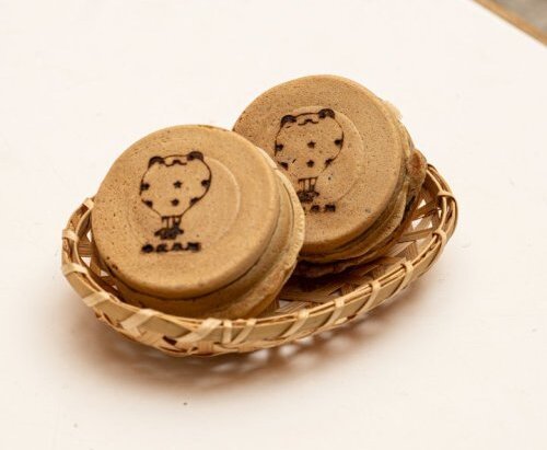 A close-up photo of red bean wheel pies infused with red oolong powder.