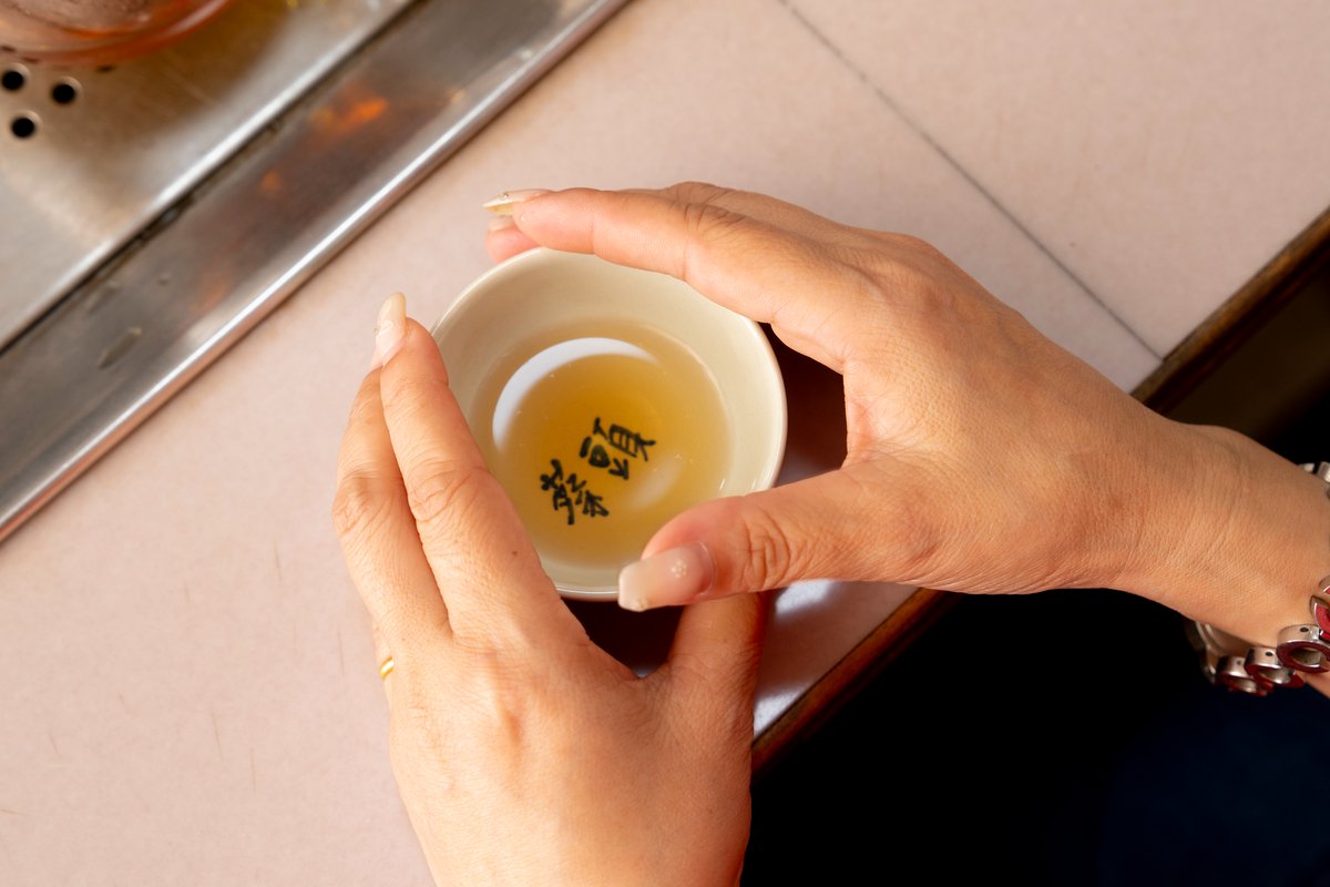 A pair of hands holding a tea cup.